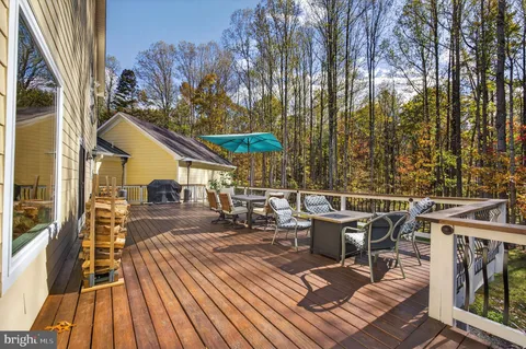a view of a patio with a table and chairs under an umbrella