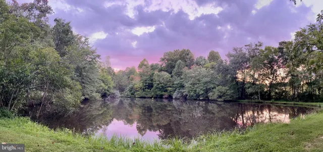 a living room with dining room and wooden floor