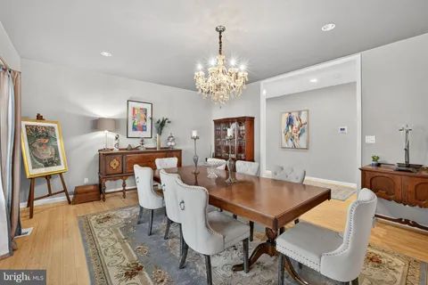 a living room with fireplace furniture and a dining table