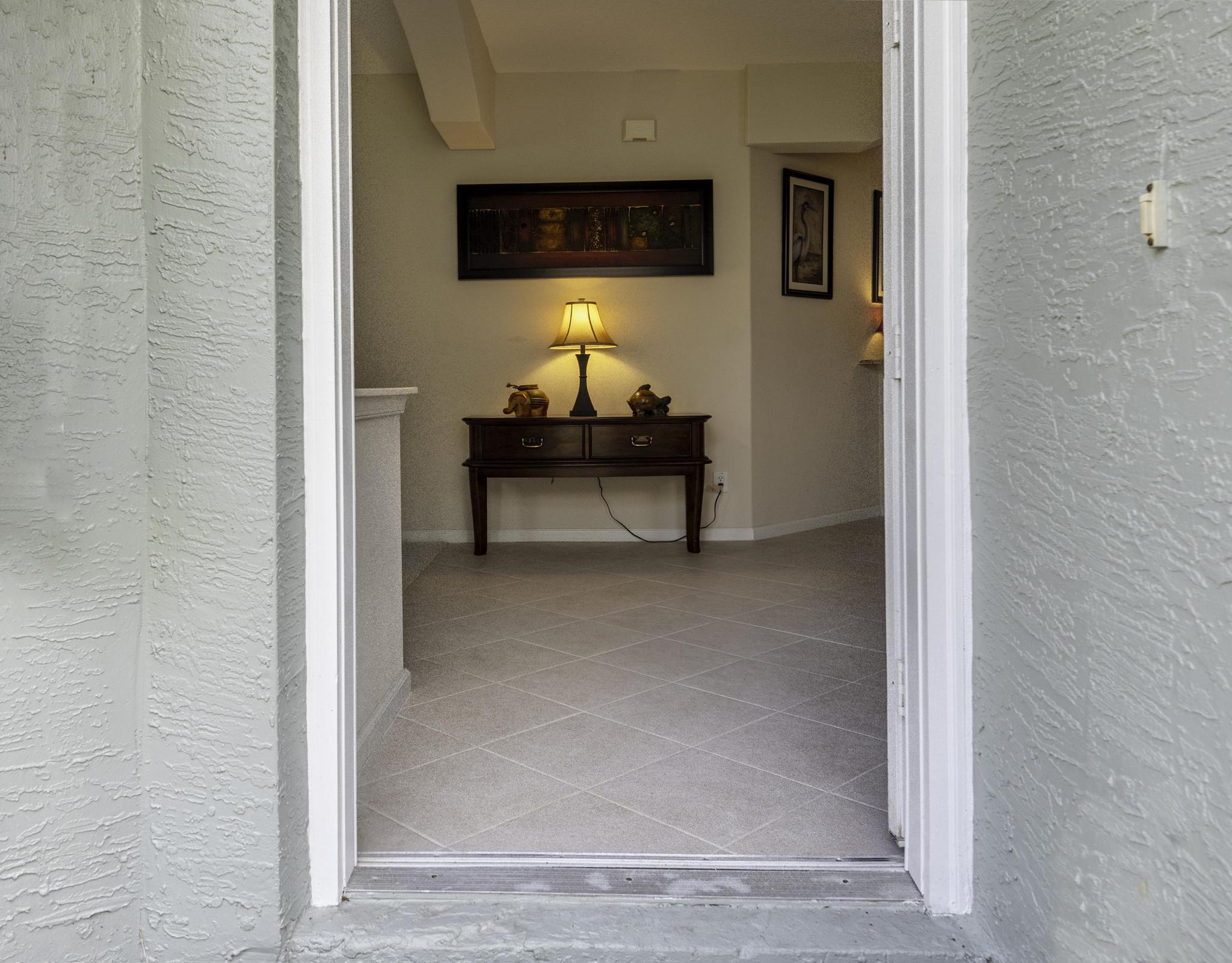 511 Northwest Red Pine Way Jensen Beach, FL 34957 - Photo 14 of 60 a living room with furniture and a wall painting