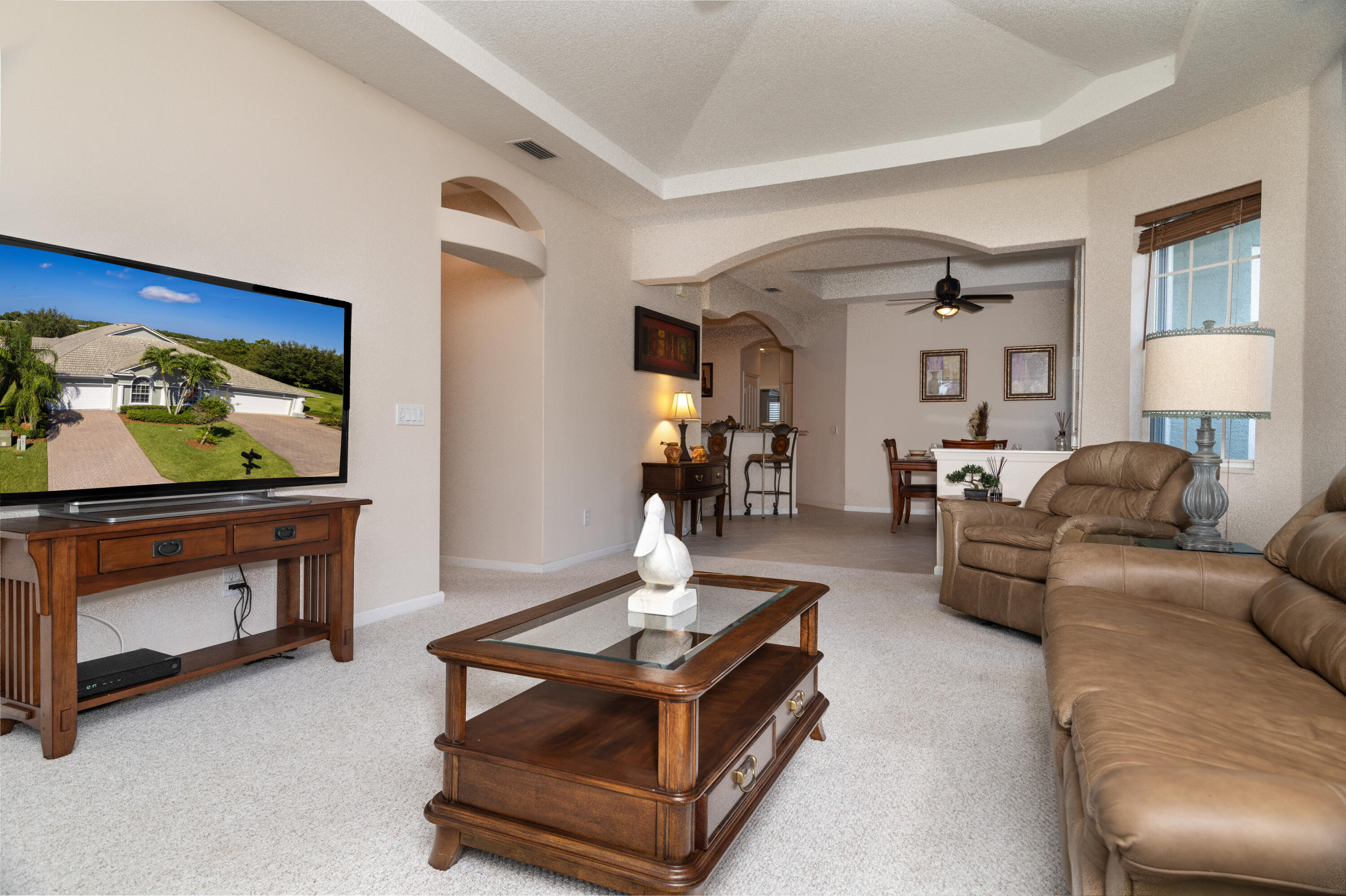 511 Northwest Red Pine Way Jensen Beach, FL 34957 - Photo 24 of 60 a living room with furniture and a flat screen tv