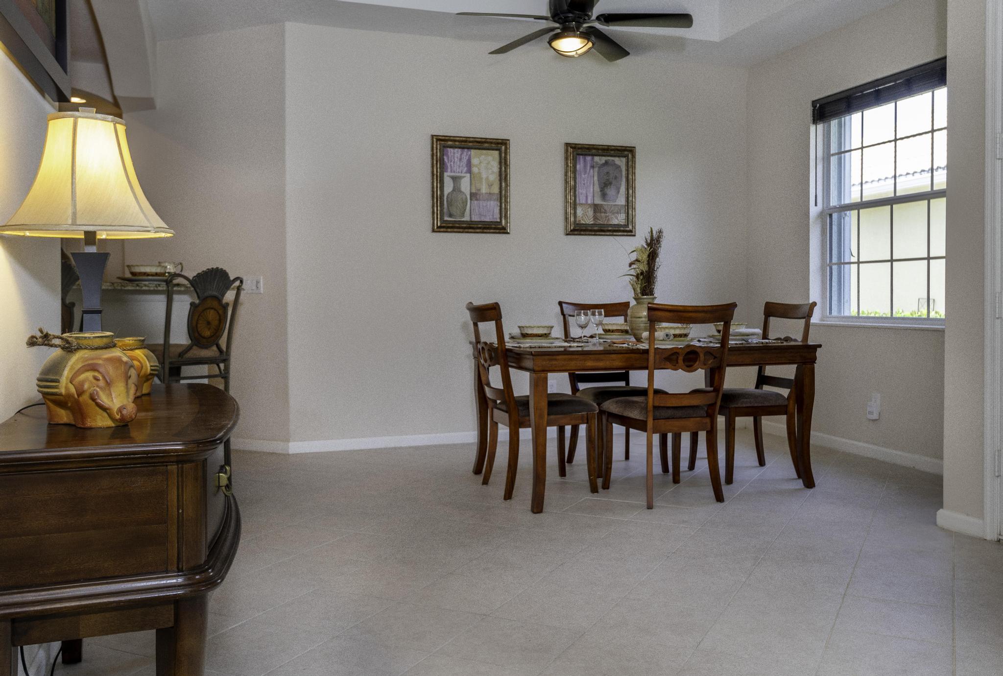 511 Northwest Red Pine Way Jensen Beach, FL 34957 - Photo 25 of 60 a view of a dining room with furniture and a window