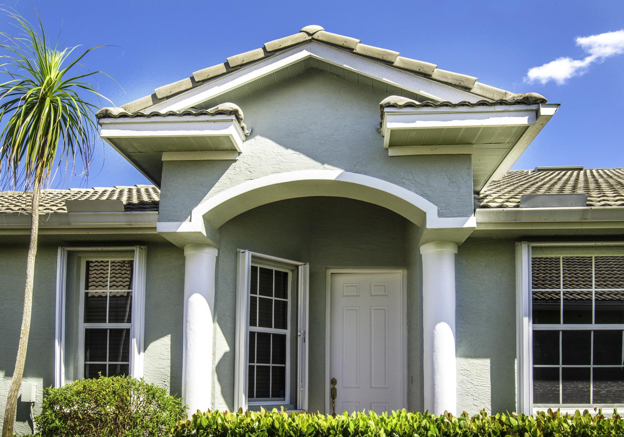 511 Northwest Red Pine Way Jensen Beach, FL 34957 - Photo 3 of 60 a view of a house with a small yard and potted plants