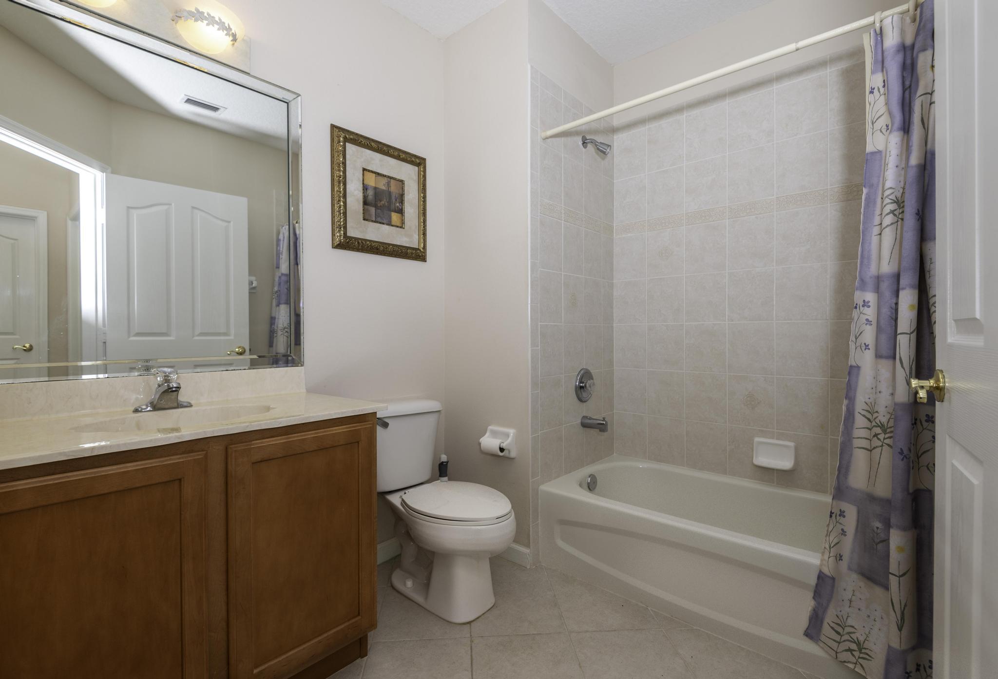 511 Northwest Red Pine Way Jensen Beach, FL 34957 - Photo 33 of 60 a bathroom with a toilet a sink and bathtub
