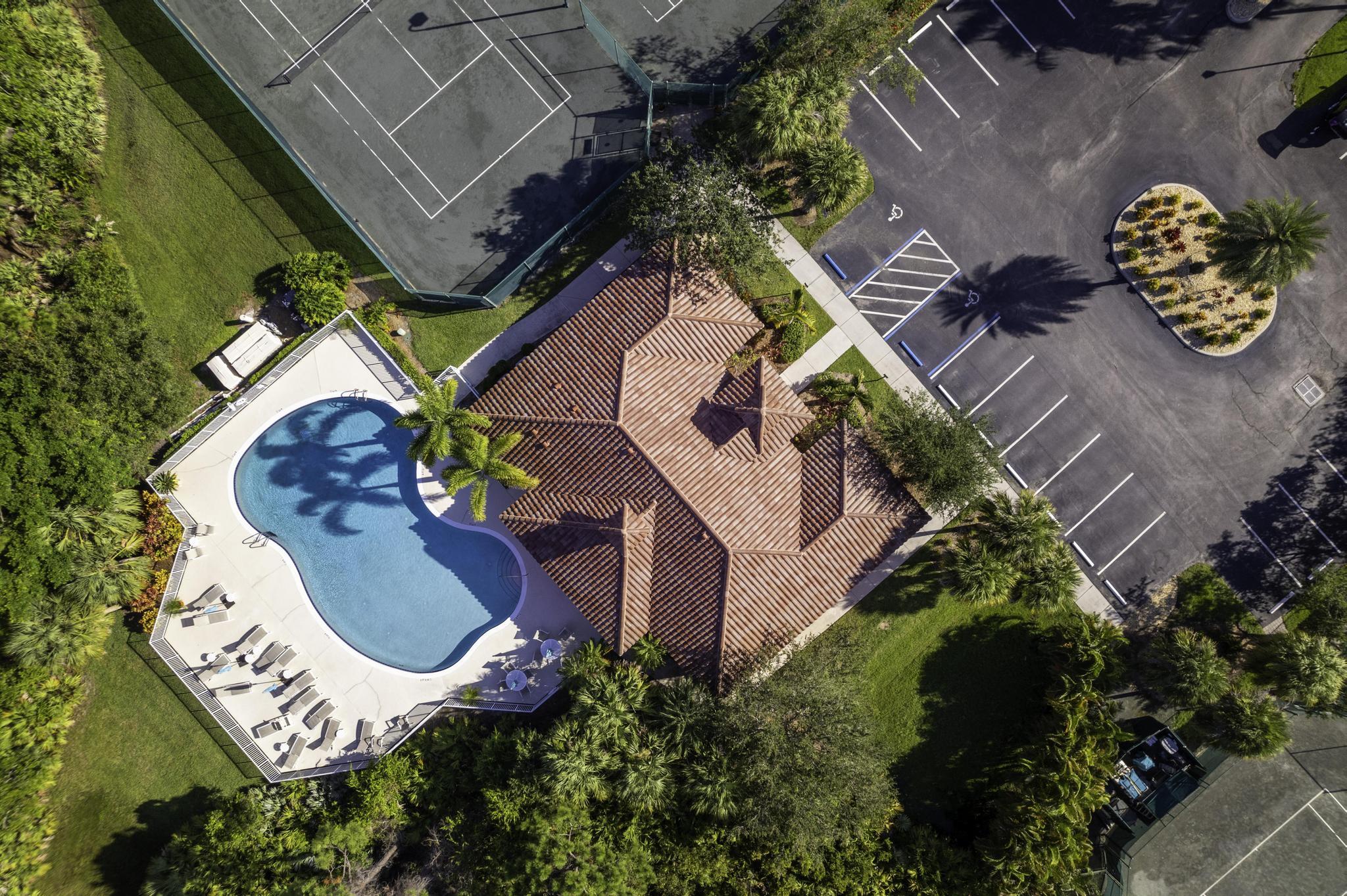 511 Northwest Red Pine Way Jensen Beach, FL 34957 - Photo 43 of 60 an aerial view of a house with a swimming pool