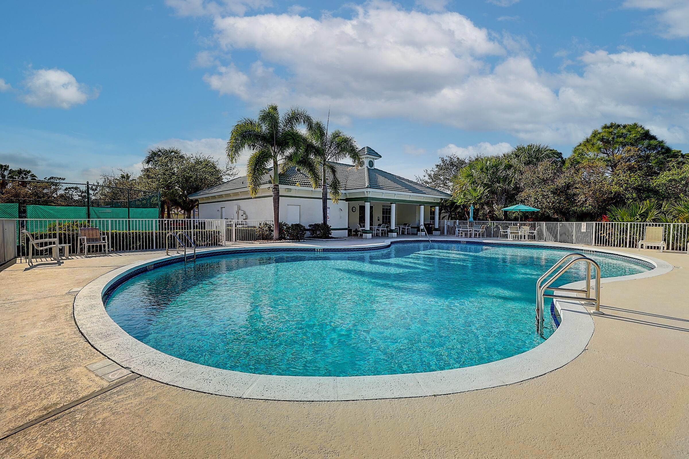 511 Northwest Red Pine Way Jensen Beach, FL 34957 - Photo 44 of 60 a view of a swimming pool with a yard