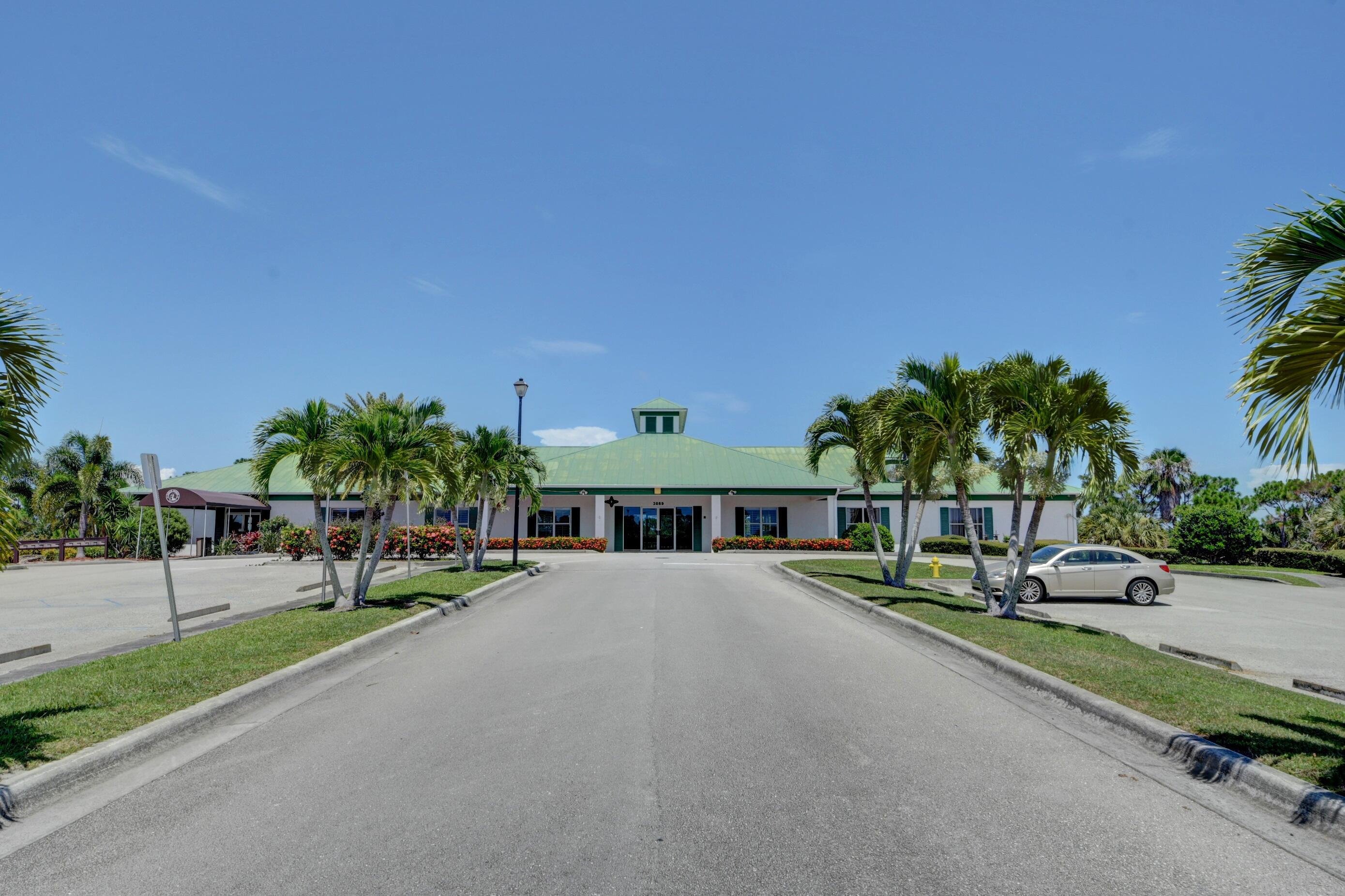 511 Northwest Red Pine Way Jensen Beach, FL 34957 - Photo 54 of 60 a view of street and with trees