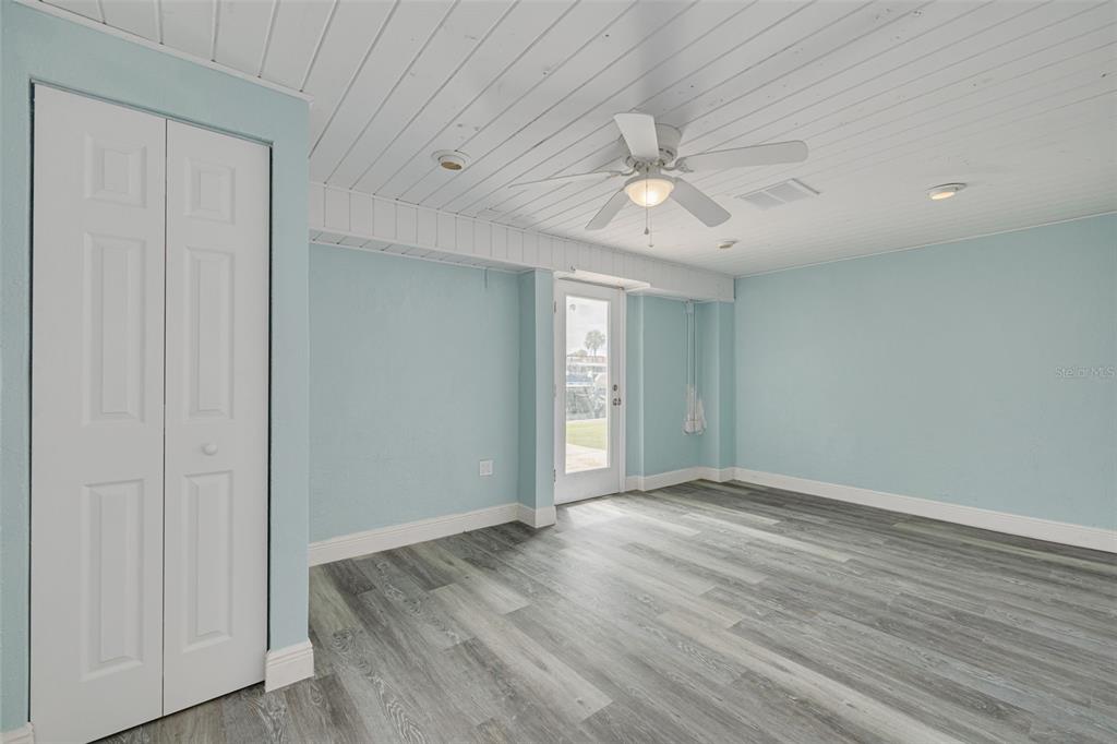 8100 Brighton Drive Port Richey, FL 34668 - Photo 14 of 68 wooden floor in an empty room with a window