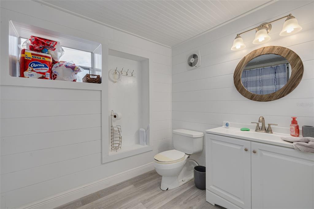 8100 Brighton Drive Port Richey, FL 34668 - Photo 16 of 68 a bathroom with a toilet a sink and a mirror