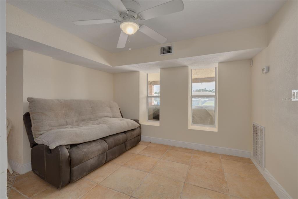 8100 Brighton Drive Port Richey, FL 34668 - Photo 17 of 68 a living room with furniture and a window