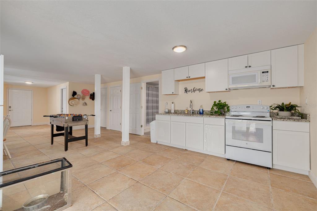 8100 Brighton Drive Port Richey, FL 34668 - Photo 20 of 68 a kitchen with white cabinets and white appliances