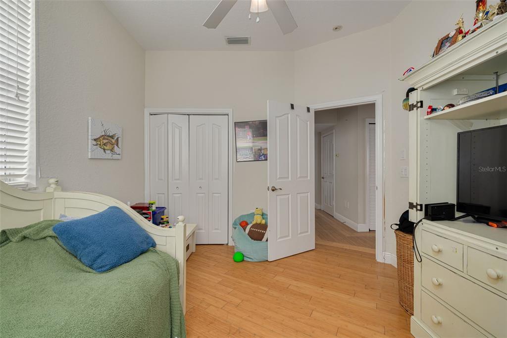 8100 Brighton Drive Port Richey, FL 34668 - Photo 27 of 68 a bedroom with a bed and a flat tv screen on dresser