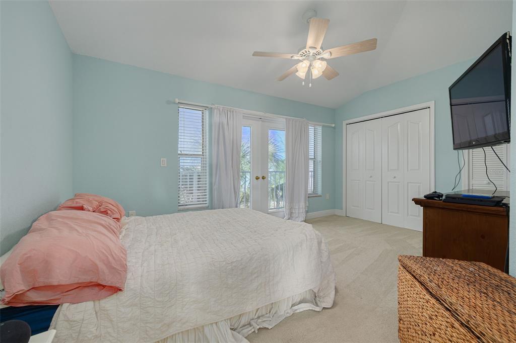 8100 Brighton Drive Port Richey, FL 34668 - Photo 32 of 68 a bedroom with a large bed and a flat tv screen on dresser