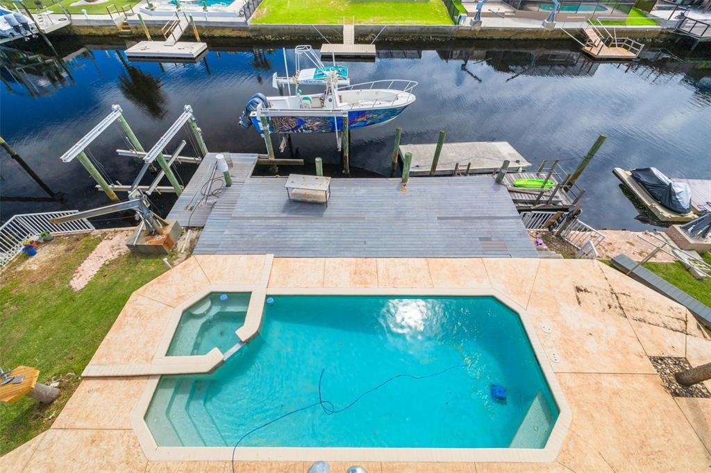 8100 Brighton Drive Port Richey, FL 34668 - Photo 33 of 68 a view of a swimming pool with chairs