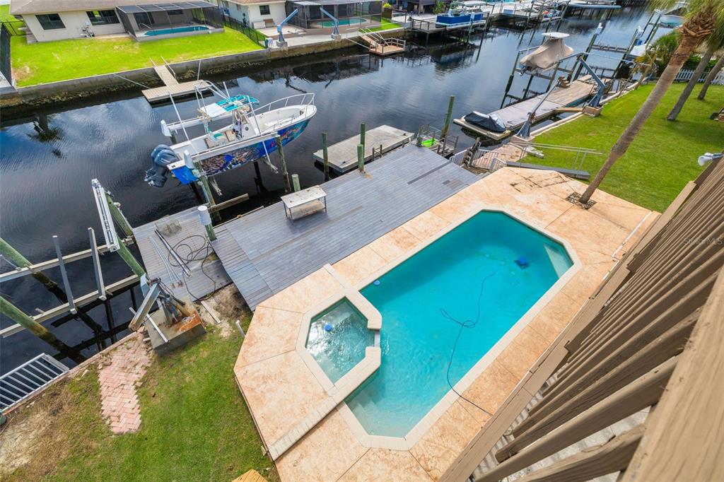 8100 Brighton Drive Port Richey, FL 34668 - Photo 34 of 68 a view of a swimming pool with lounge chair