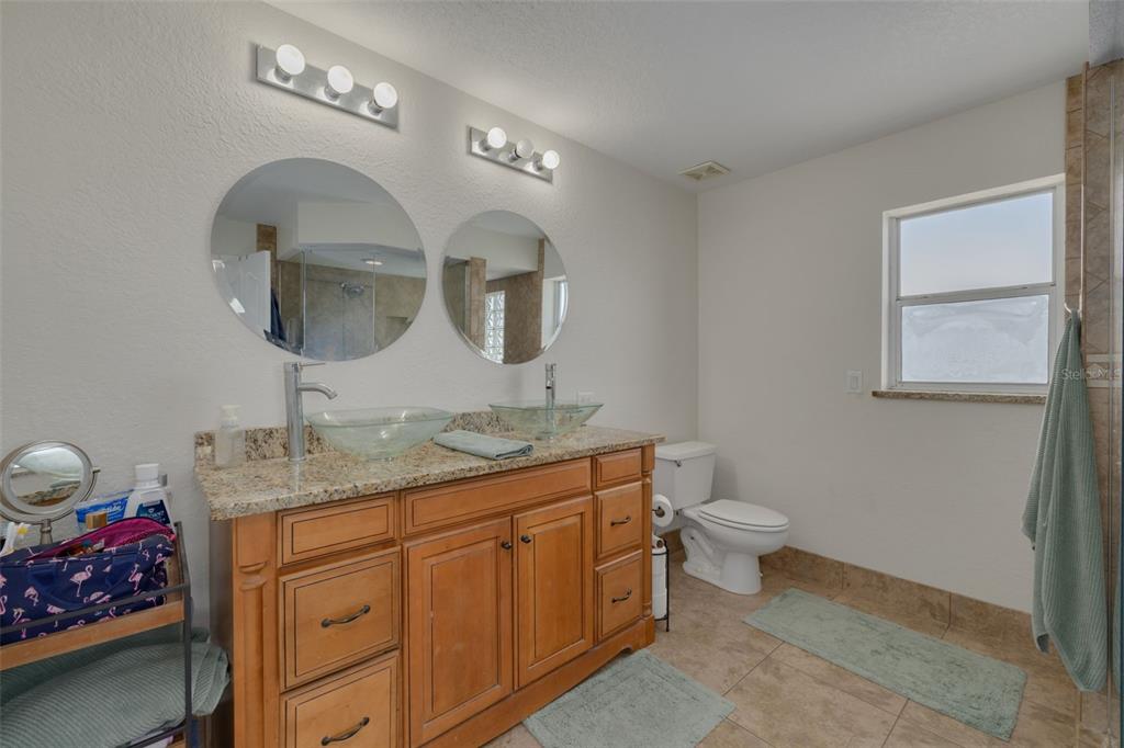 8100 Brighton Drive Port Richey, FL 34668 - Photo 39 of 68 a bathroom with a toilet sink and mirror