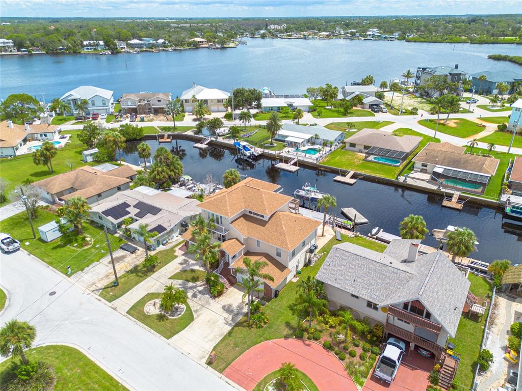 8100 Brighton Drive Port Richey, FL 34668 - Photo 4 of 68 an aerial view of residential houses with outdoor space and lake view