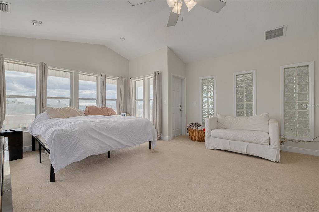 8100 Brighton Drive Port Richey, FL 34668 - Photo 41 of 68 a spacious bedroom with a bed and a couch
