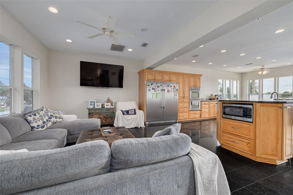8100 Brighton Drive Port Richey, FL 34668 - Photo 57 of 68 a living room with furniture and a flat screen tv