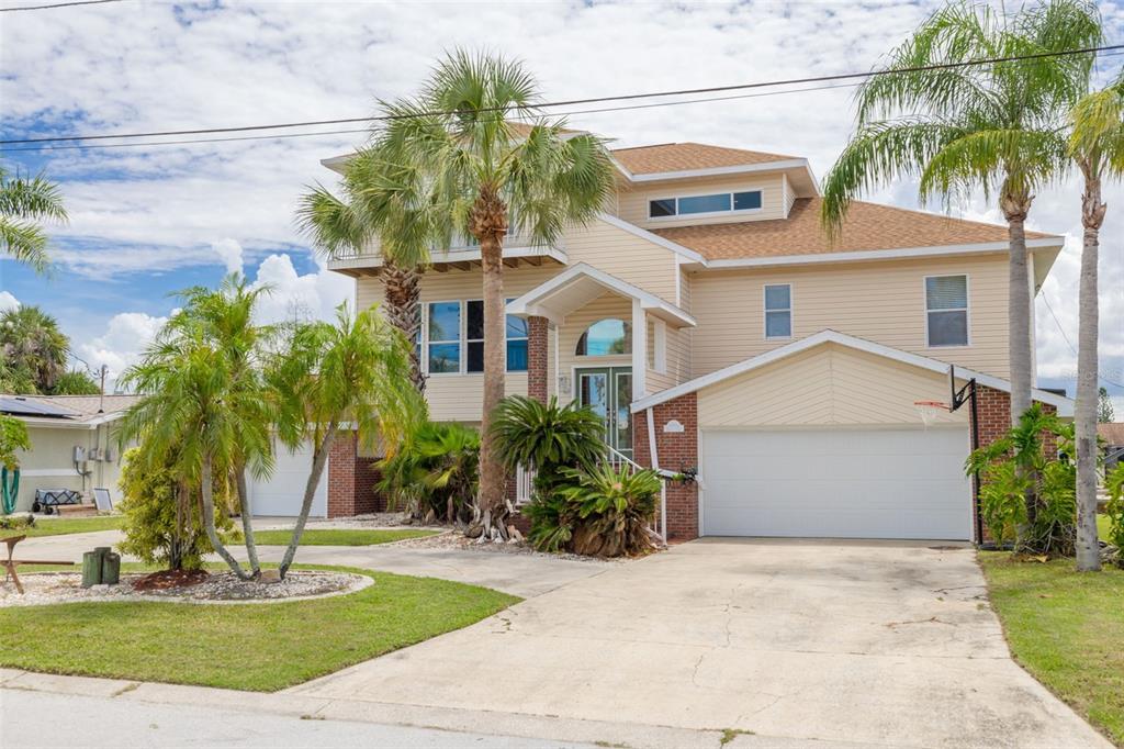 8100 Brighton Drive Port Richey, FL 34668 - Photo 62 of 68 a front view of a house with a garden