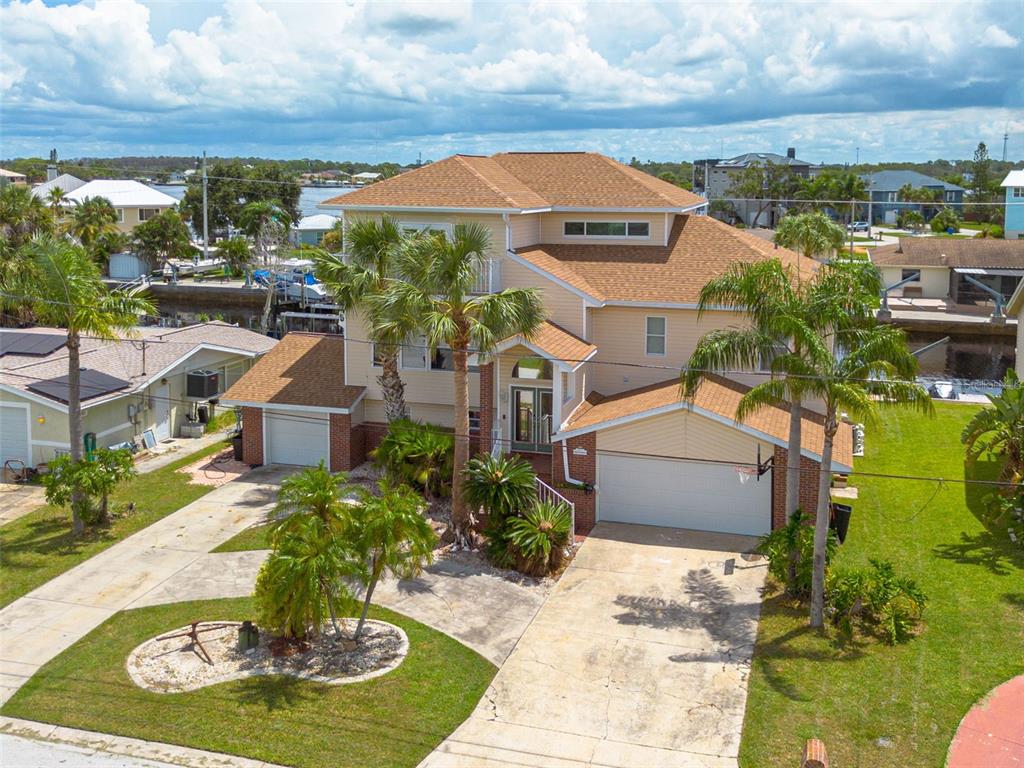 8100 Brighton Drive Port Richey, FL 34668 - Photo 64 of 68 a front view of a house with a yard