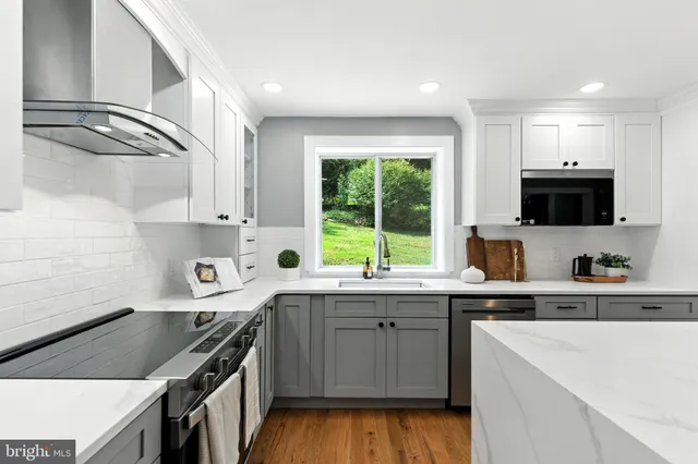 a kitchen with a sink a stove and cabinets