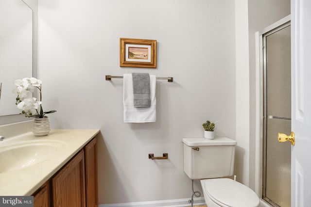 a bathroom with a sink mirror and toilet
