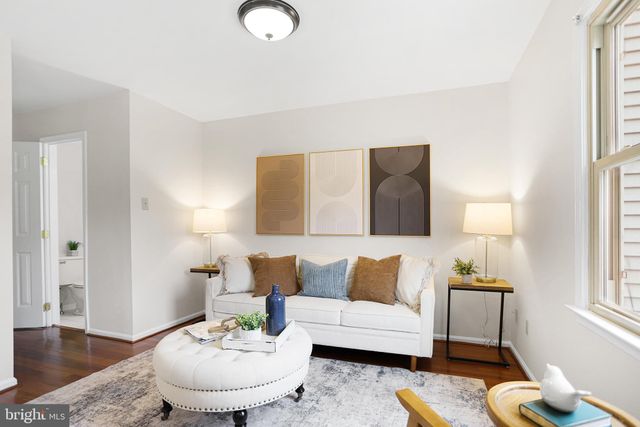 a living room with furniture and a lamp