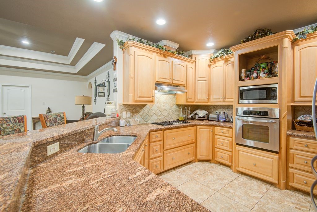 24910 Farm To Market 2004 Angleton, TX 77515 - Photo 13 of 50 a kitchen with stainless steel appliances granite countertop a sink and cabinets