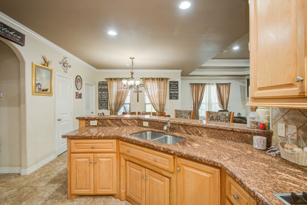 24910 Farm To Market 2004 Angleton, TX 77515 - Photo 15 of 50 a kitchen with granite countertop a sink and white cabinets