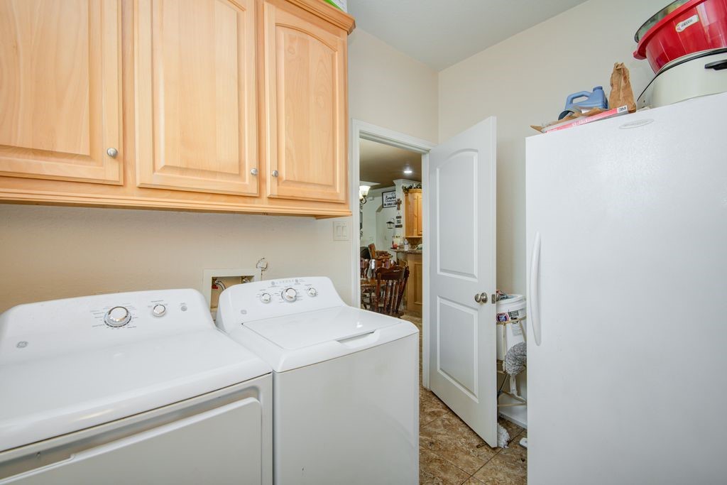 24910 Farm To Market 2004 Angleton, TX 77515 - Photo 18 of 50 a view of storage and utility room with washer and dryer