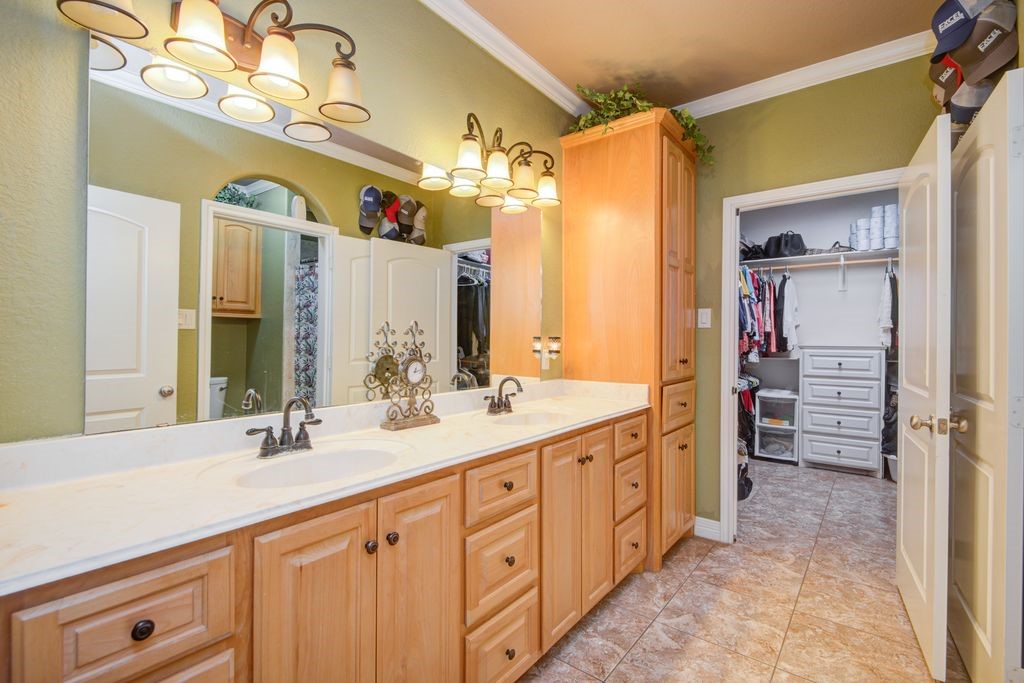 24910 Farm To Market 2004 Angleton, TX 77515 - Photo 22 of 50 a spacious bathroom with a double vanity sink a large mirror and a shower