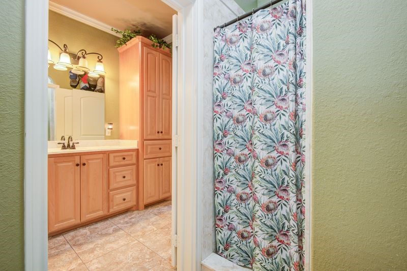 24910 Farm To Market 2004 Angleton, TX 77515 - Photo 25 of 50 a spacious bathroom with a granite countertop sink a mirror and a shower curtain