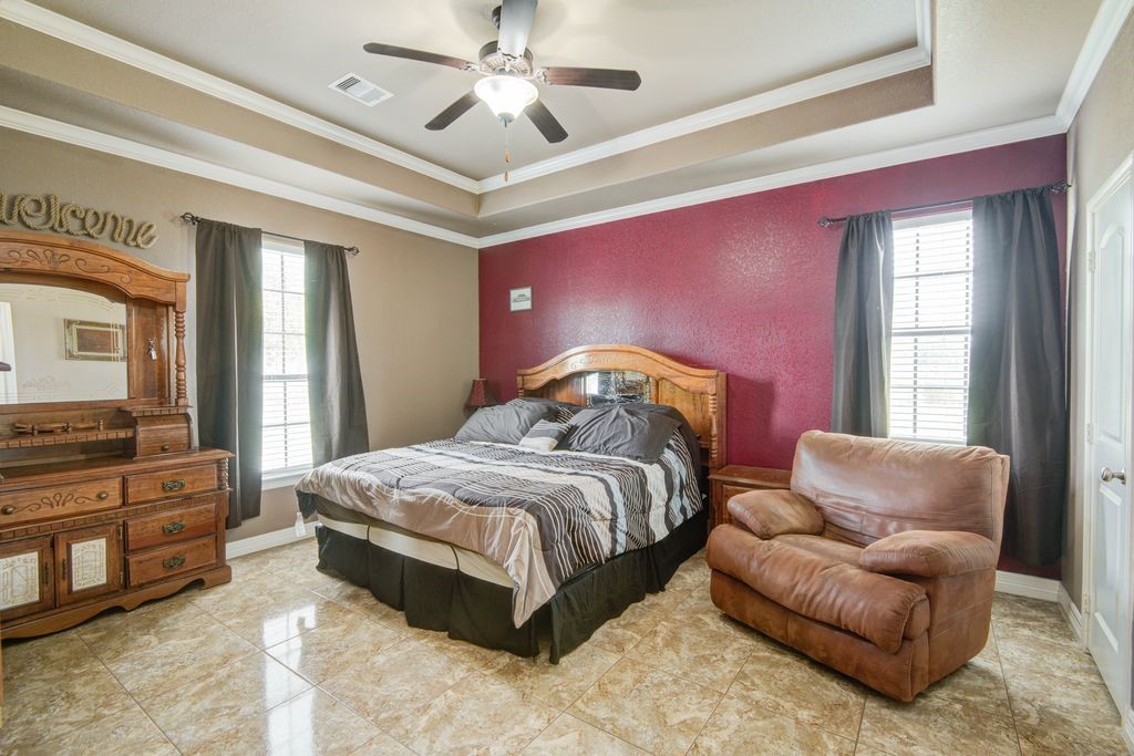 24910 Farm To Market 2004 Angleton, TX 77515 - Photo 26 of 50 a spacious bedroom with a bed couch and window