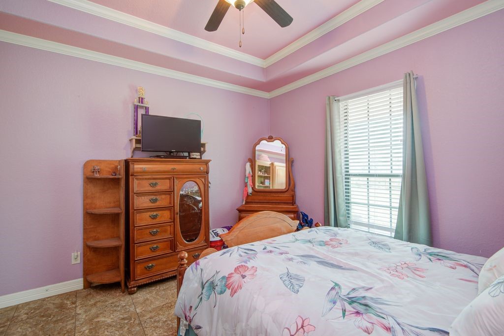 24910 Farm To Market 2004 Angleton, TX 77515 - Photo 32 of 50 a bedroom with a bed and a television