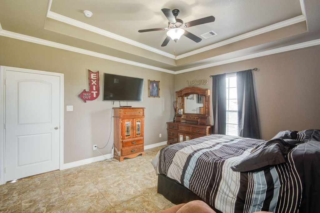 24910 Farm To Market 2004 Angleton, TX 77515 - Photo 33 of 50 a bedroom with a bed and a flat screen tv