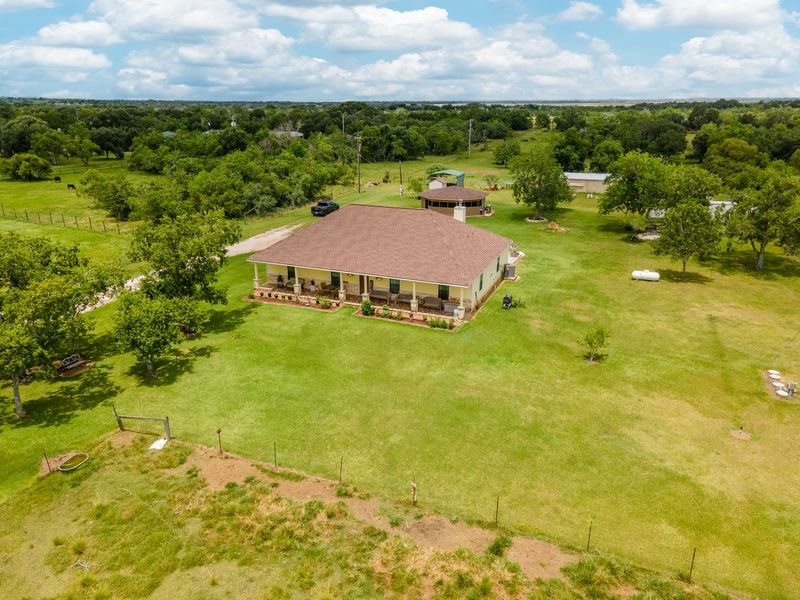 24910 Farm To Market 2004 Angleton, TX 77515 - Photo 39 of 50 a view of a lake with lawn chairs and large trees