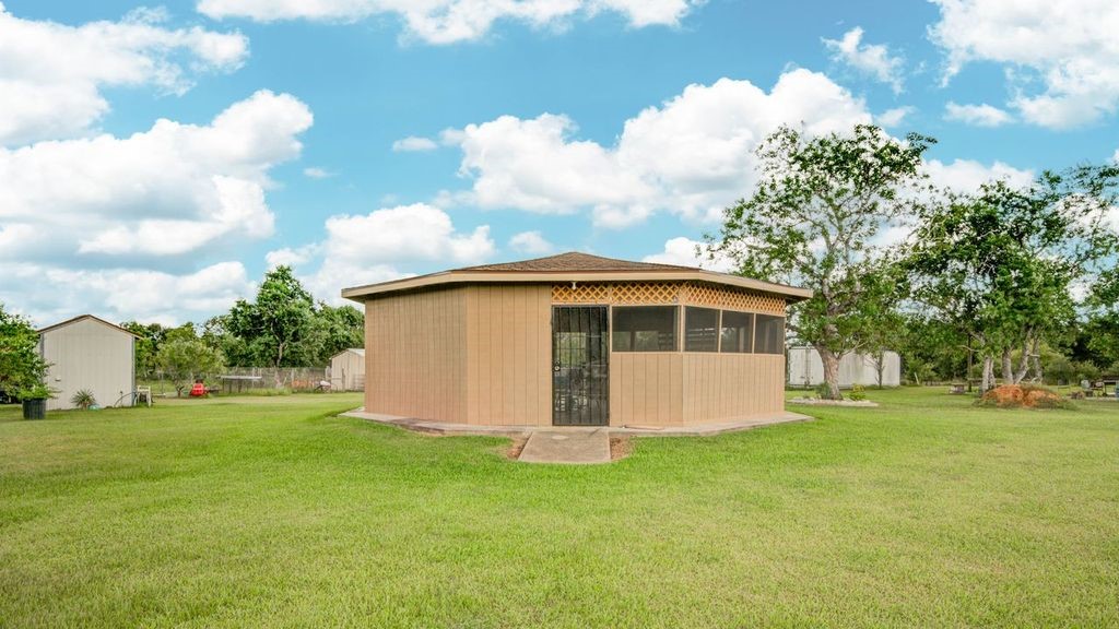 24910 Farm To Market 2004 Angleton, TX 77515 - Photo 44 of 50 a front view of a house with garden