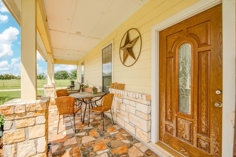 24910 Farm To Market 2004 Angleton, TX 77515 - Photo 5 of 50 a view of a dining room with furniture wooden floor and a rug