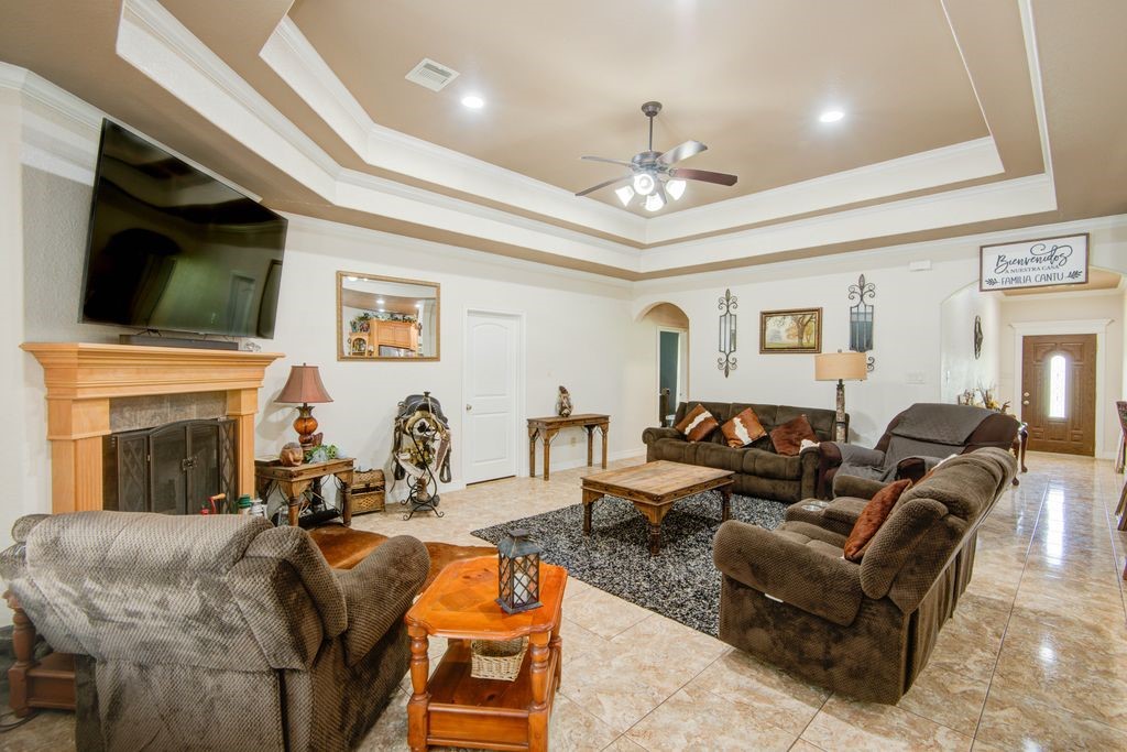 24910 Farm To Market 2004 Angleton, TX 77515 - Photo 8 of 50 a living room with furniture a fireplace and a flat screen tv