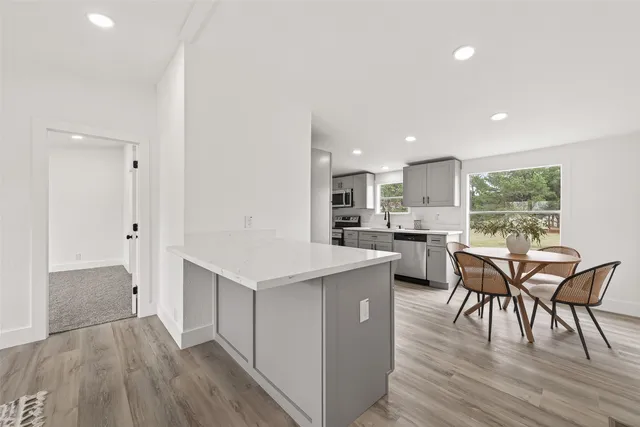 a view of kitchen with cabinets and wooden floor