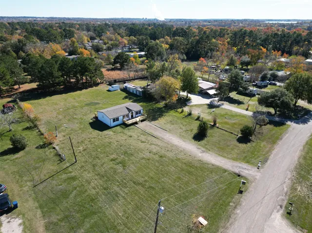 an aerial view of a house with yard