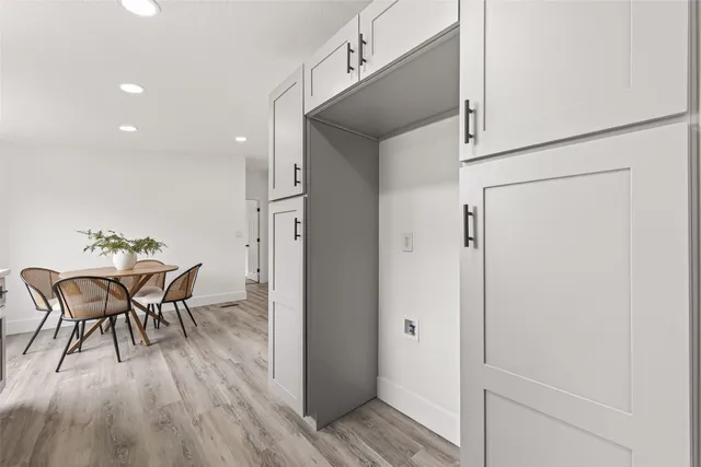 a dining room with furniture and wooden floor