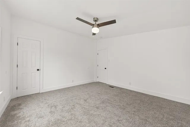 a view of a room with a ceiling fan
