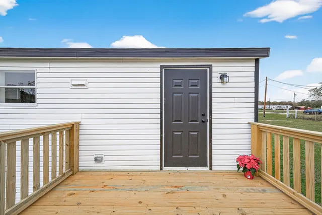 a view of a porch with wooden floor and fence