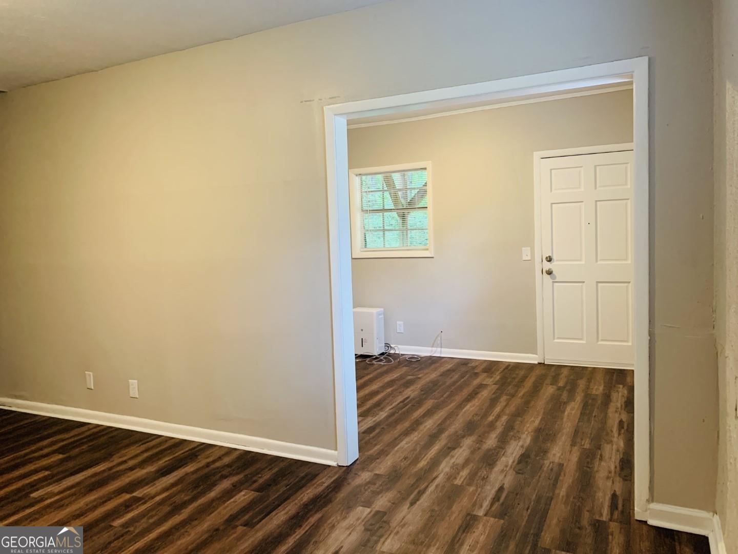 1069 Laurel Lane Northwest, Unit B Conyers, GA 30012 - Photo 22 of 28 an empty room with wooden floor and a window