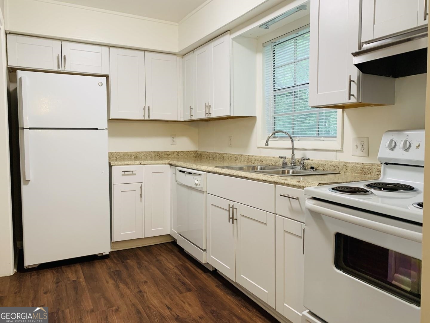 1069 Laurel Lane Northwest, Unit B Conyers, GA 30012 - Photo 5 of 28 a kitchen with white cabinets sink and white appliances