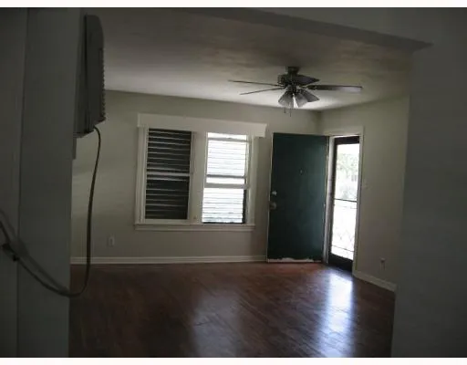 a view of a livingroom with a ceiling fan and window