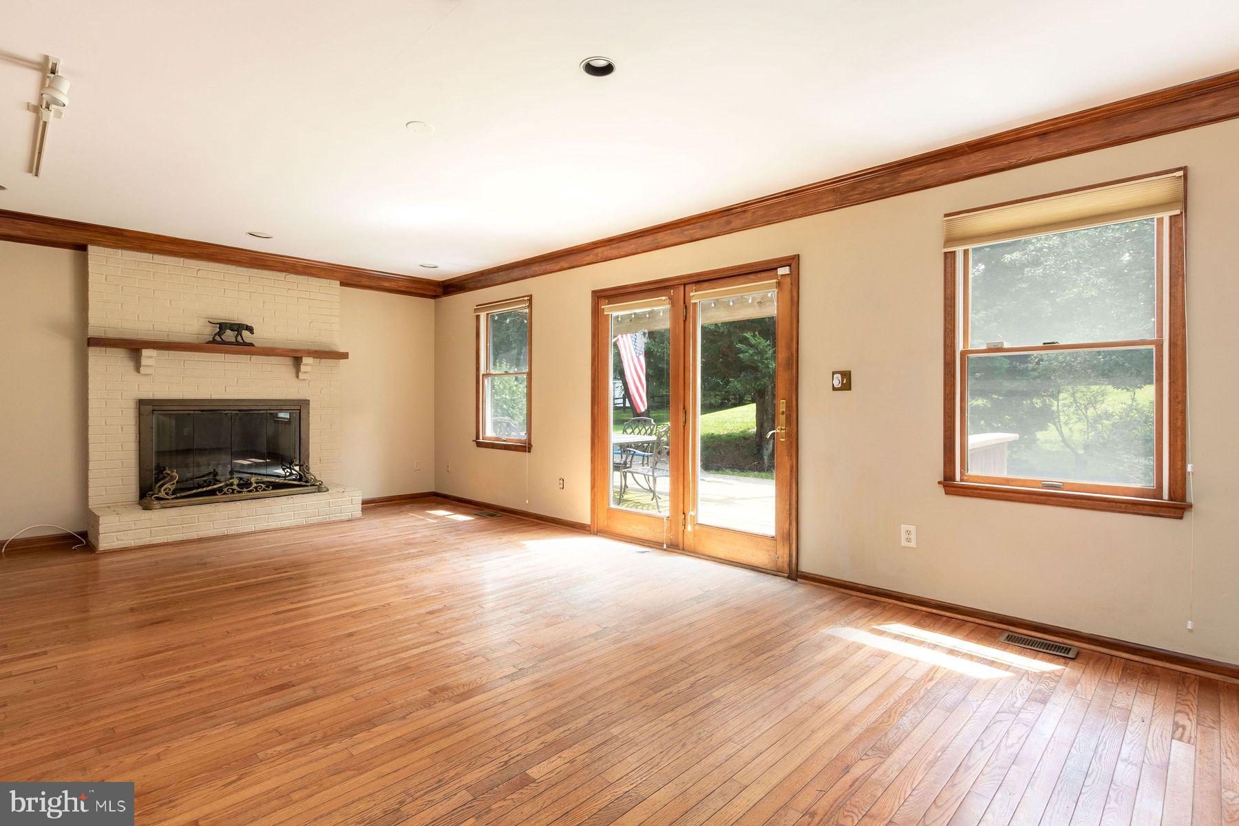 4887 Danielle Drive Doylestown, PA 18902 - Photo 18 of 35 a view of empty room with wooden floor and fireplace