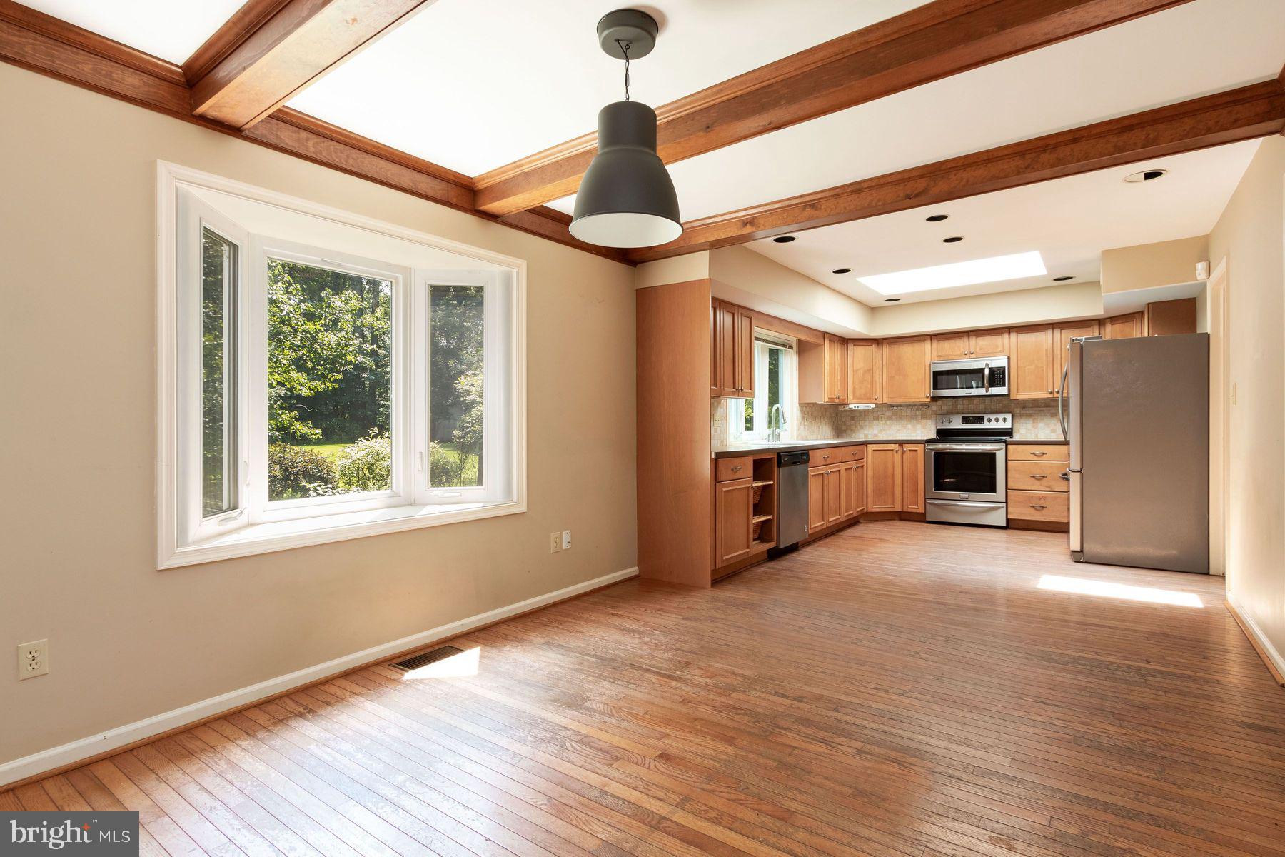 4887 Danielle Drive Doylestown, PA 18902 - Photo 20 of 35 a view of an empty room with window wooden floor and a kitchen
